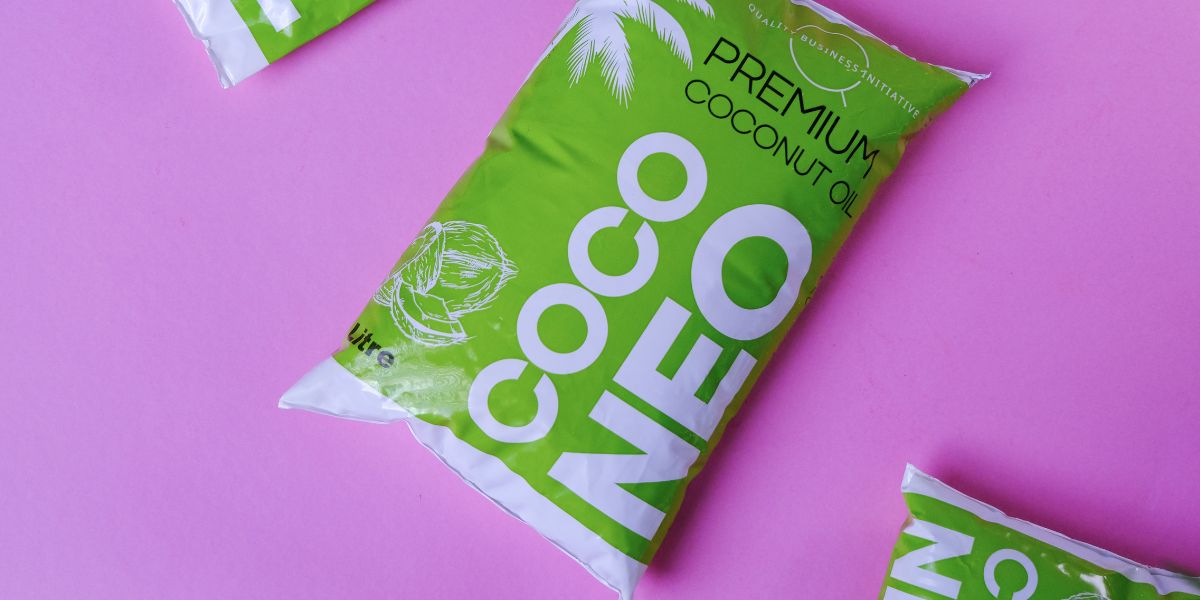 Coco Neo 1L Kerala cold pressed coconut oil pouch displayed on a pink background